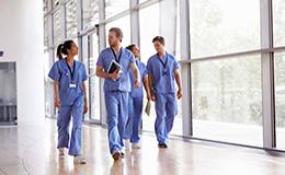 Medical staff walking the halls talking.